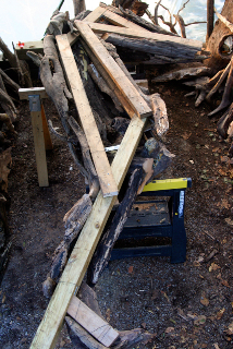 Armature half covered with driftwood.