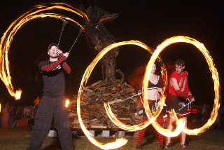 Fire performers spin fire around the effigy.