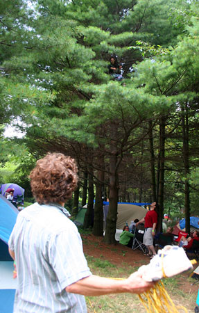 Fellow prepares to throw a rope-bound shoe to Leah.
